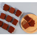 Bear sponge and toast shaped sponges, some on a wooden plate