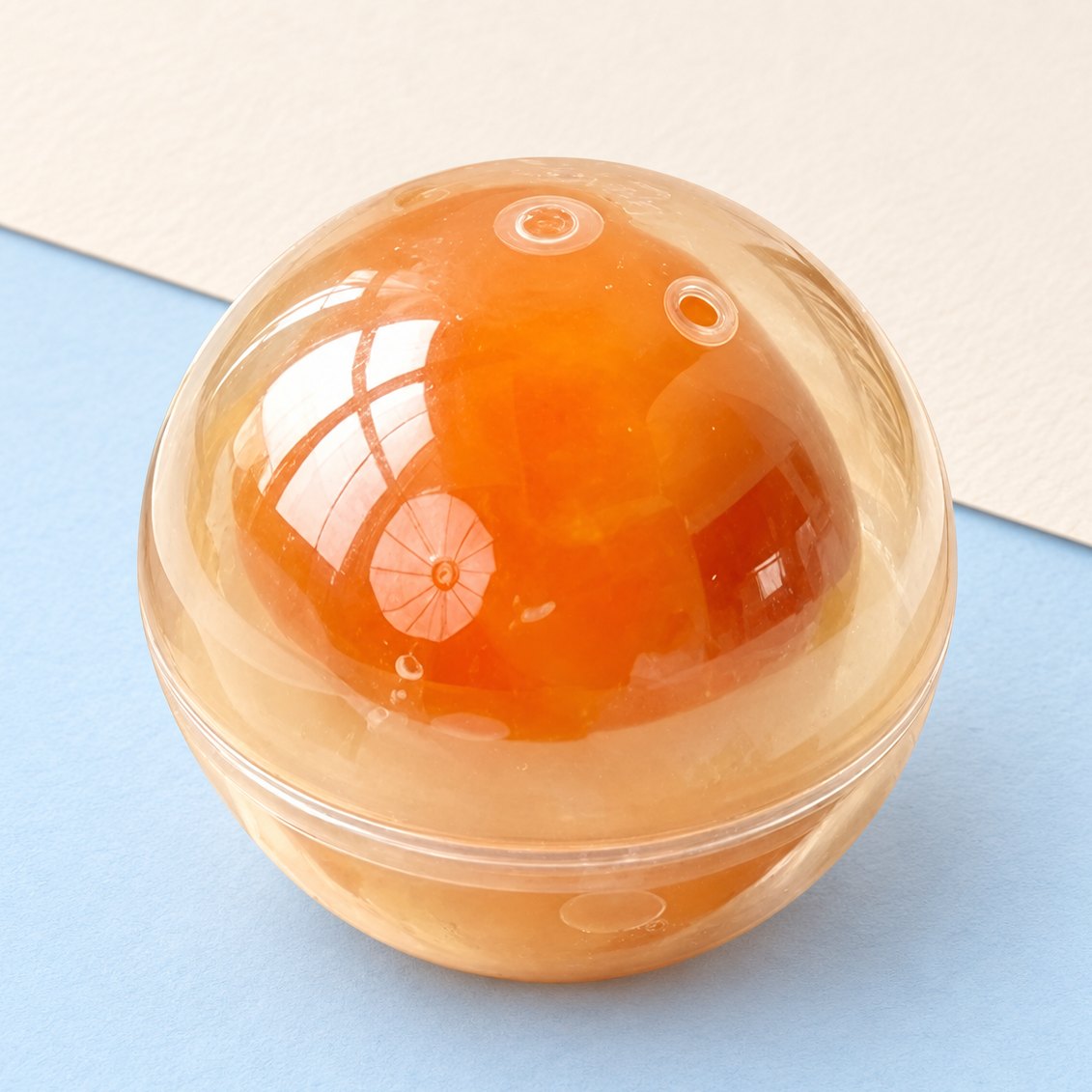 Æggeblomme-squishy, rund bold på 7 cm, produktfoto på pastelfarvet papir