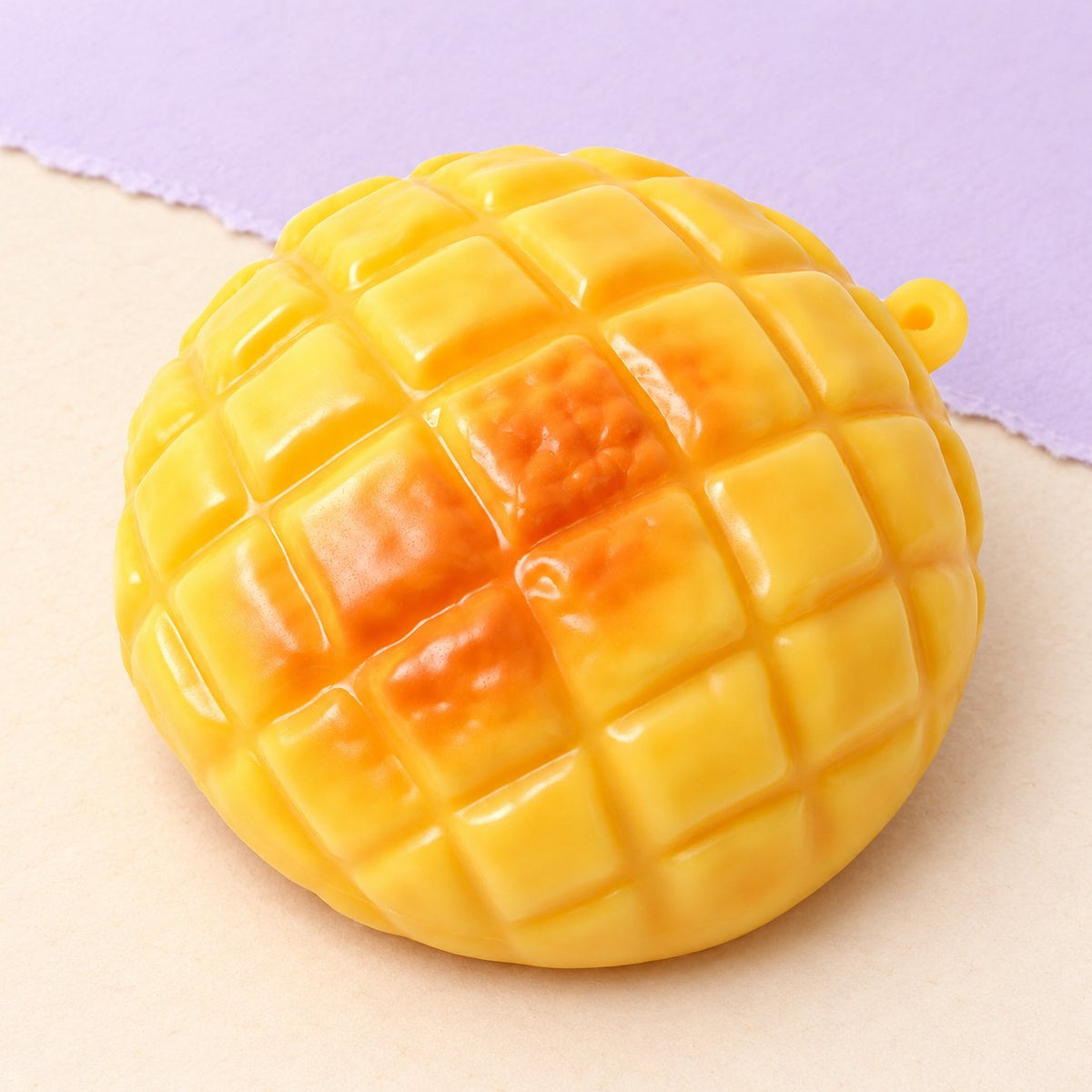 Ananasbroodje squishy van 9 cm op pastelkleurig papier