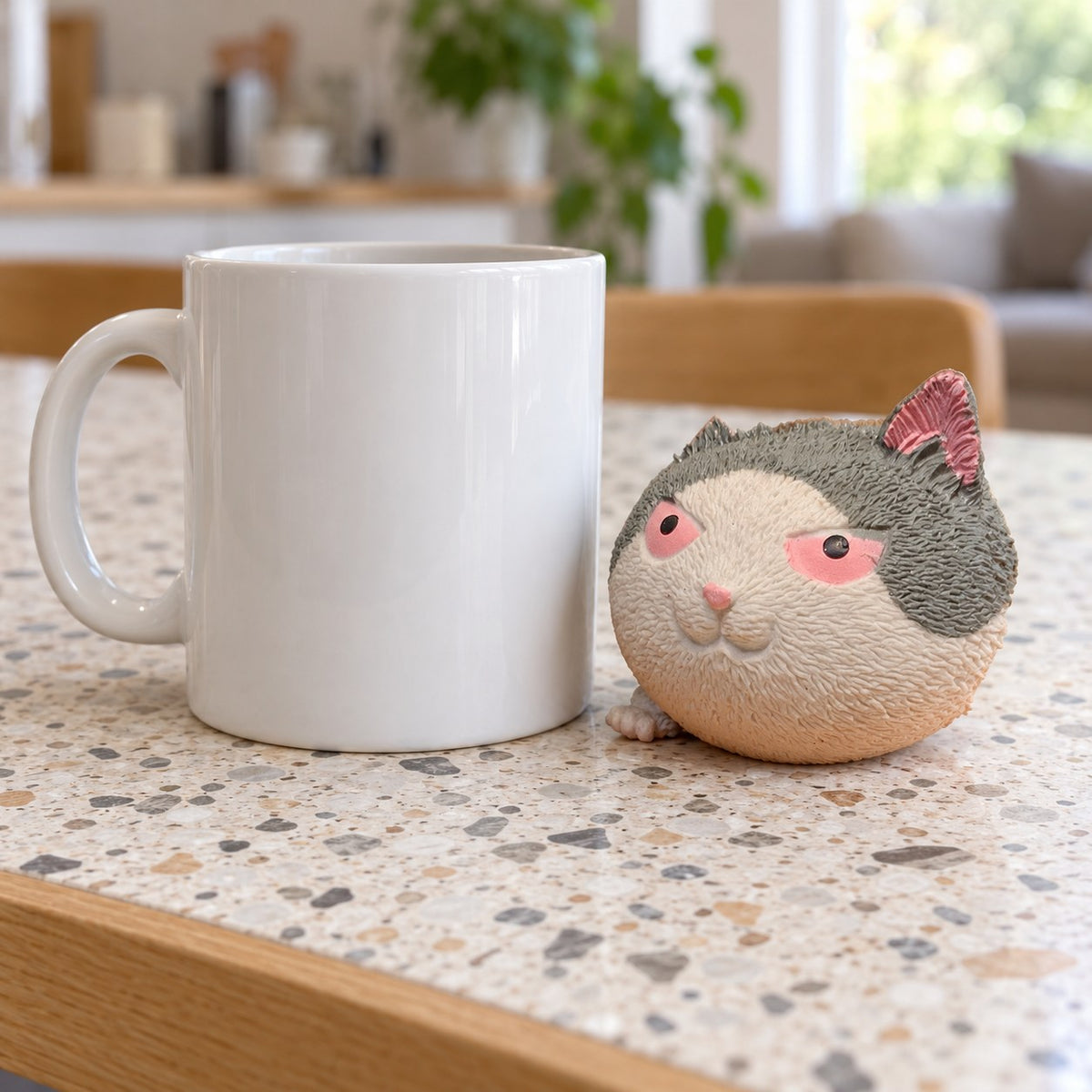 Angry cat squishy, next to a coffee mug for size comparison