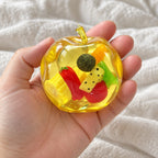 Apple squishy, held toward the camera, first-person view