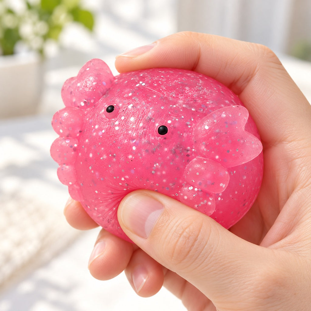 Axolotl Mochi Squishy with Glitter, being squeezed by hand, soft and squishy