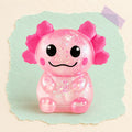Axolotl squishy glitter – Glitter Axolotl Squishy, Slow Rising (Pink), product photo on pastel paper