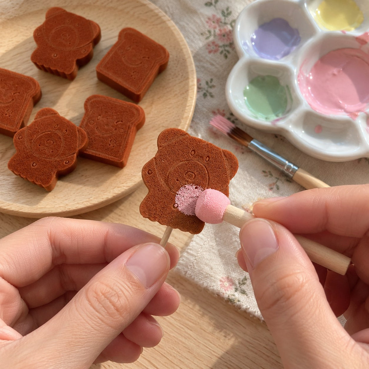 Bear craft sponges for DIY squishies, while a bear is painted into a mini squishy
