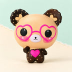 Bear squishy with heart glasses slow rising – Bear Squishy with Heart Glasses, Slow Rising, 12 cm (Beige), product photo on pastel paper