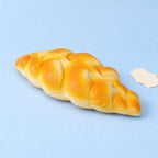 Braided bread squishy slow rising – Braided Bread Squishy, 19 cm, product photo on pastel paper