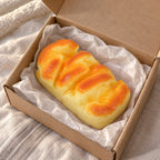 Brioche squishy (11 cm), unboxed from a parcel with tissue paper