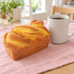 Brioche squishy slow rising (15 cm), next to a coffee mug for size comparison