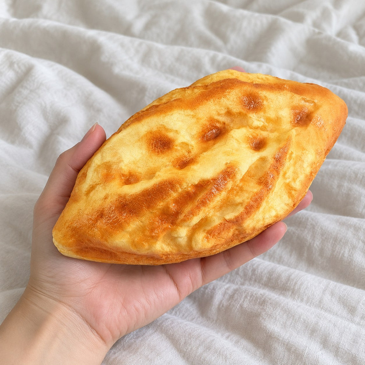 Diamond bread squishy, held toward the camera, first-person view