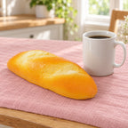 Dinner roll squishy slow rising, next to a coffee mug for size comparison