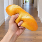 Dinner roll squishy slow rising, being squeezed by hand, soft and squishy