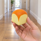 Toast squishy mini slow rising (4.8 cm), held in a hand to show the real size