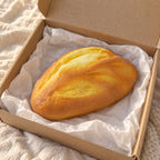 Bread loaf squishy soft, unboxed from a parcel with tissue paper