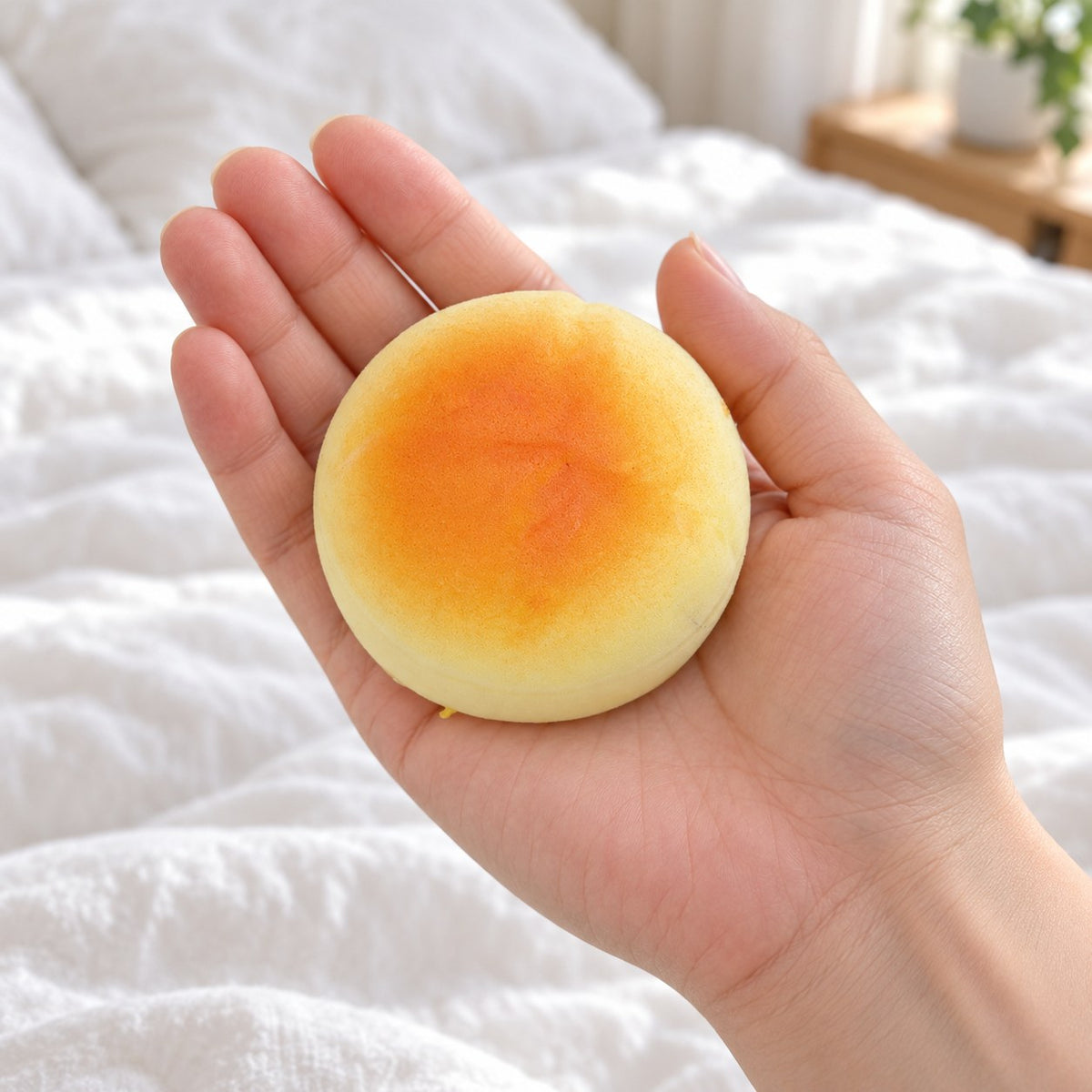 Round Bun Squishy, Small Bread Roll 6 cm, held in a hand to show the real size