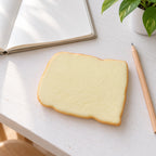 Toast squishy soft, on a desk with a notebook and pencil