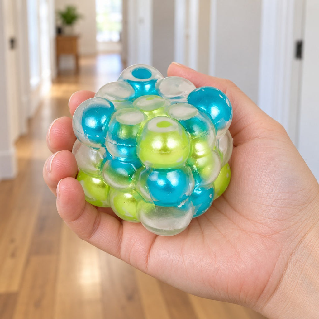 Bubble Cube Squishy, Pearl Balls Inside, 6 cm (Blue-green mix), held in a hand to show the real size