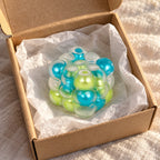 Bubble cube squishy (Blue-green mix), unboxed from a parcel with tissue paper