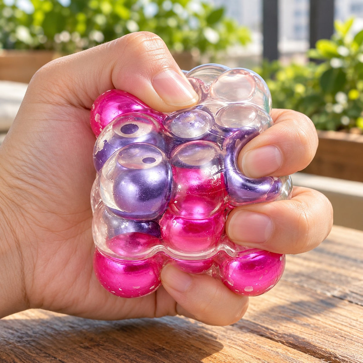 Bubble Cube Squishy, Pearl Balls Inside, 6 cm (Purple-red mix), being squeezed by hand, soft and squishy