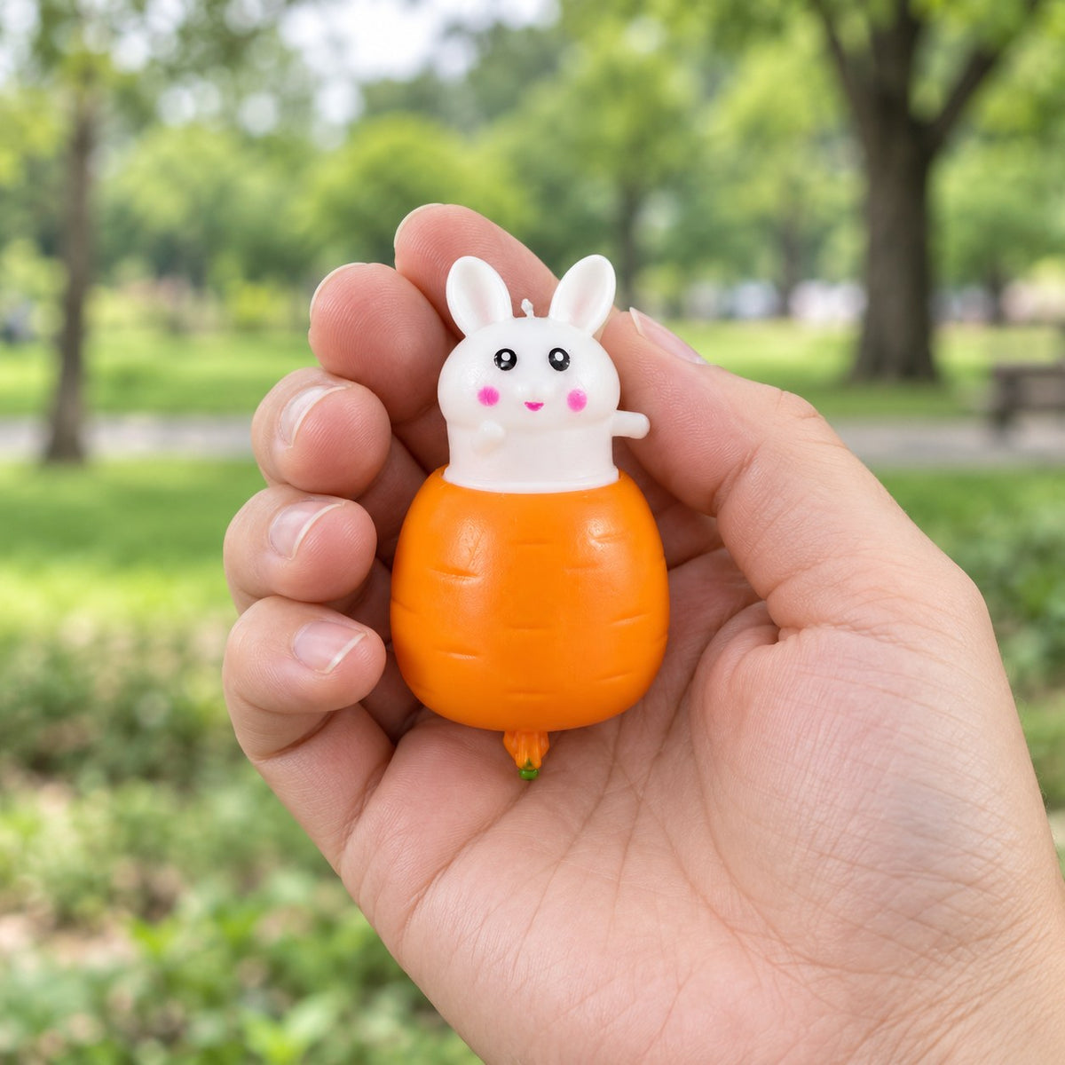 Bunny Pop-Up Squishy, Rabbit in a Carrot, held in a hand to show the real size