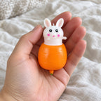 Bunny squishy kawaii, held toward the camera, first-person view