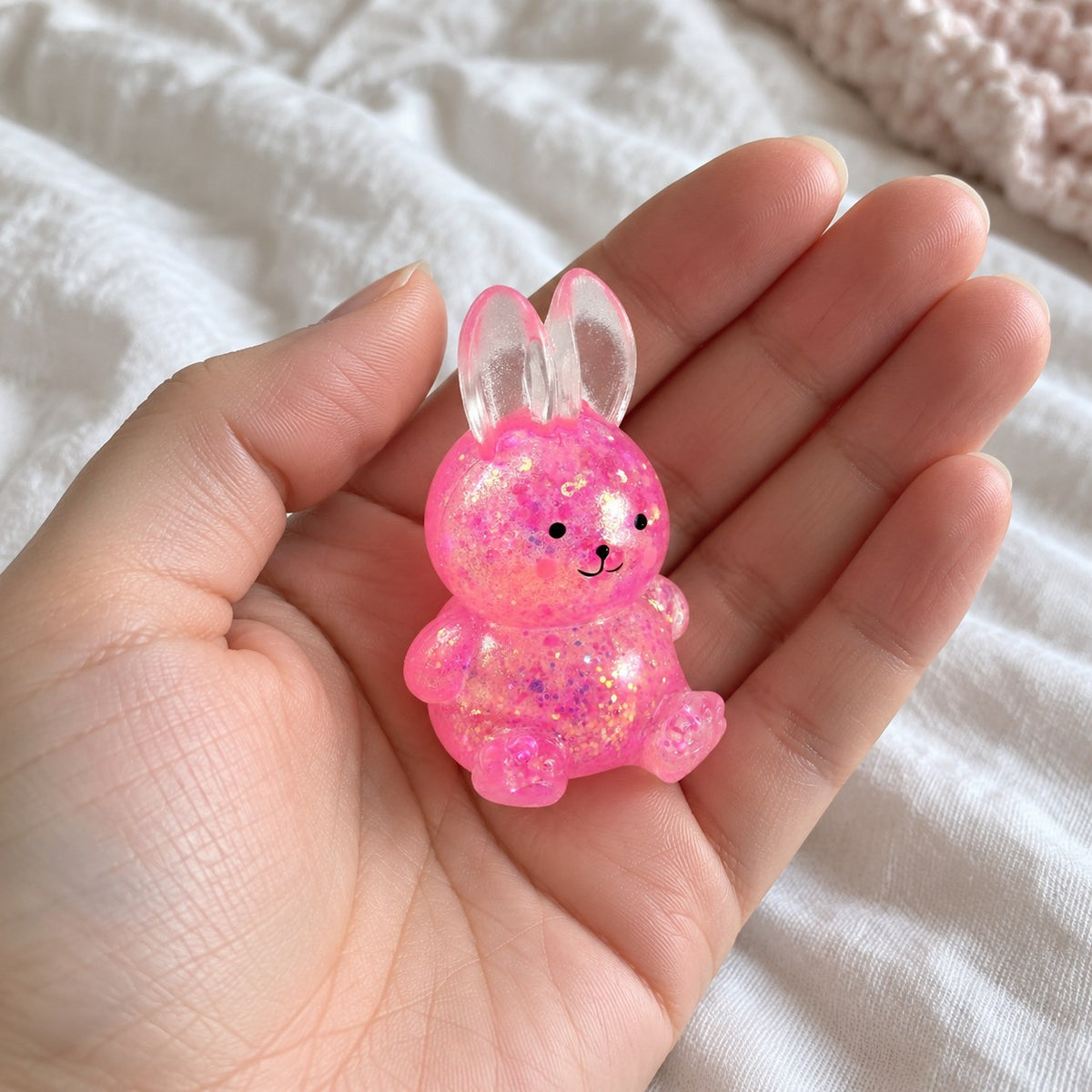 Bunny squishy glitter, held toward the camera, first-person view