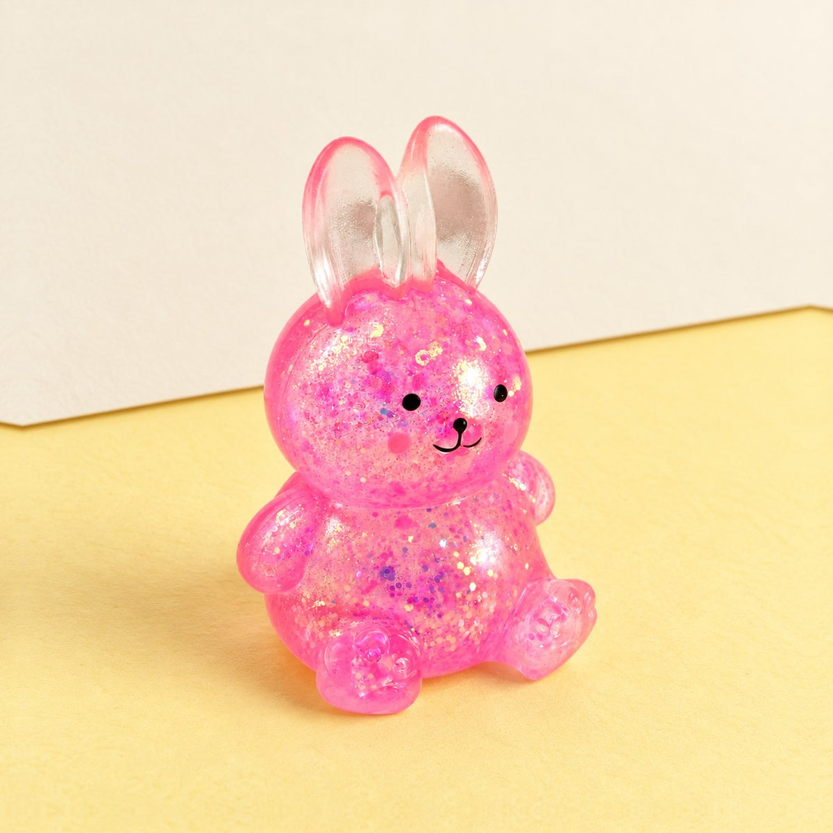 Bunny squishy stretchy – Bunny Squishy with Glitter, Sugar Style, product photo on pastel paper