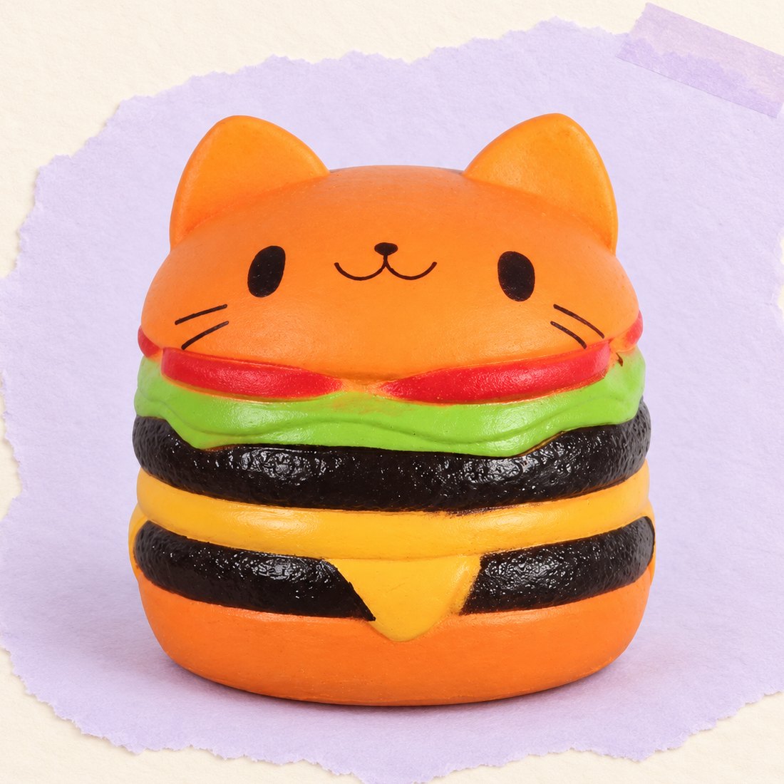 Orange burger-squishy, produktfoto på pastelfarvet papir