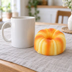 Canelé Squishy, French Pastry 9 cm, next to a coffee mug for size comparison