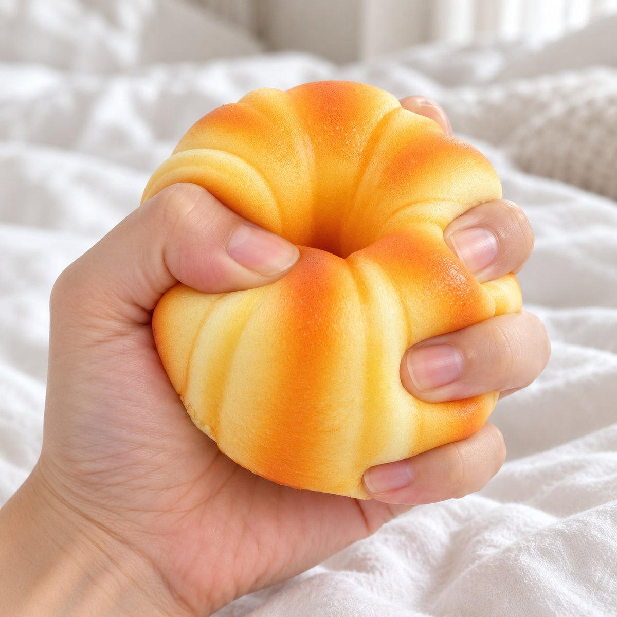 Canelé Squishy, French Pastry 9 cm, being squeezed by hand, soft and squishy