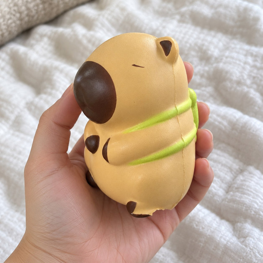 Capybara squishy kawaii (Turtle, light beige), held toward the camera, first-person view