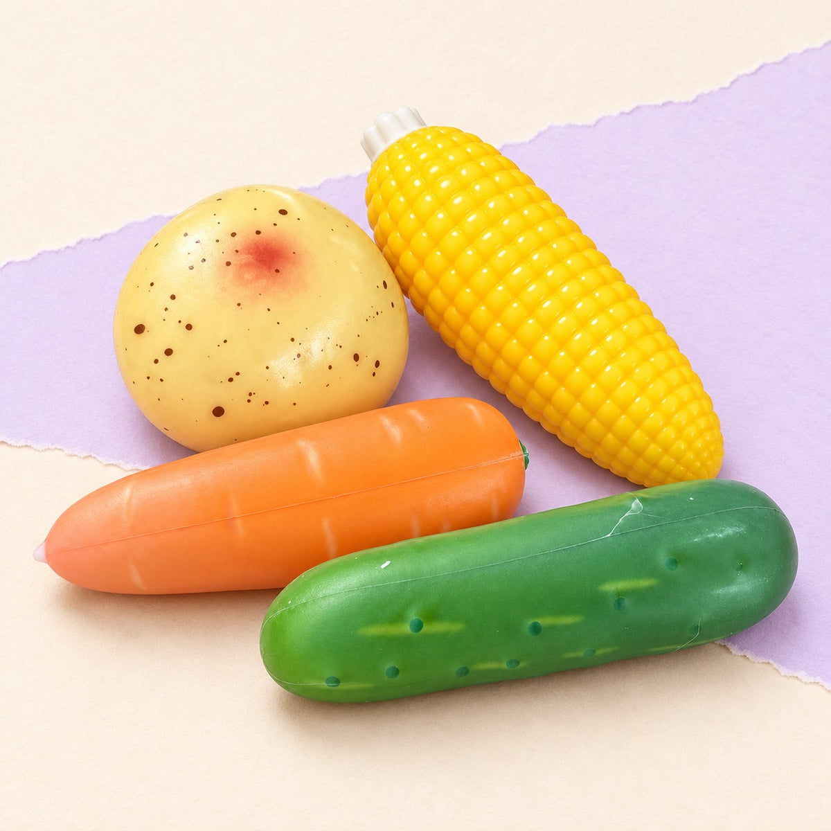 Carrot squishy set crunchy – Crunchy Veggie Squishy Set of 4, product photo on pastel paper