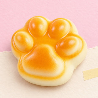 Squishy pata de gato slow rising – Squishy de pata de gato, bollo dorado de 7 cm, foto del producto sobre papel pastel