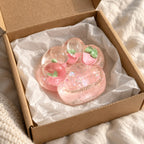 Cat paw squishy glitter (Strawberry pink), unboxed from a parcel with tissue paper