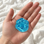 Cat paw squishy mini jelly (Blue), held toward the camera, first-person view