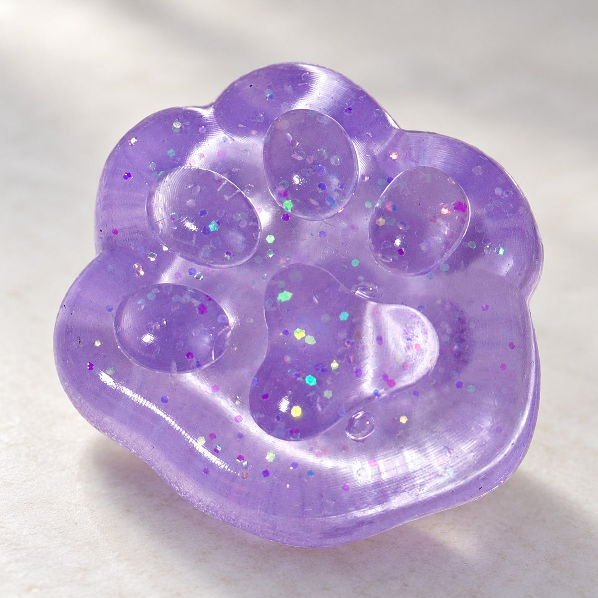 Mini Jelly Cat Paw Squishy, 4 cm (Purple glitter), close-up of the glitter