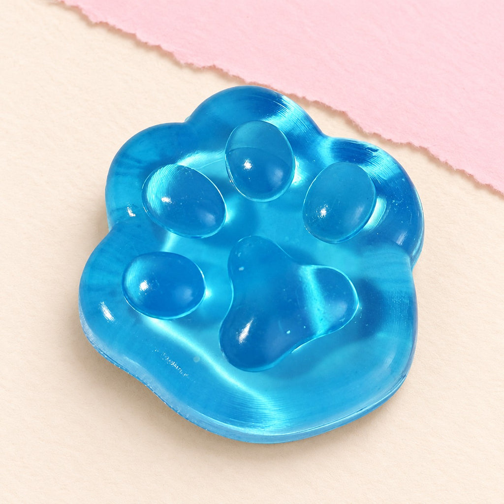 Cat paw squishy mini jelly – Mini Jelly Cat Paw Squishy, 4 cm (Blue), product photo on pastel paper