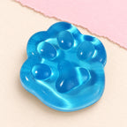 Cat paw squishy mini jelly – Mini Jelly Cat Paw Squishy, 4 cm (Blue), product photo on pastel paper