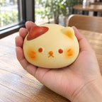 Cat bun squishy, held in a hand to show the real size