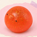 Chick squishy mochi – Mochi Squishy Chick with Glitter, product photo on pastel paper