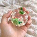 Apple squishy clear, held toward the camera, first-person view