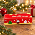 Christmas Butter Stick Squishy, Slow Rising (red), in a Christmas scene with fir branches and fairy lights