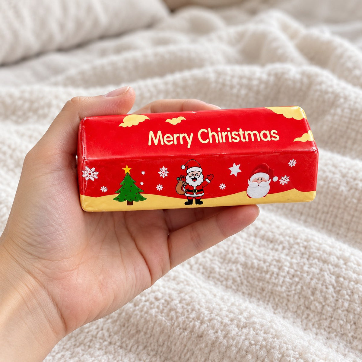 Christmas Butter Stick Squishy, Slow Rising (red), held toward the camera, first-person view