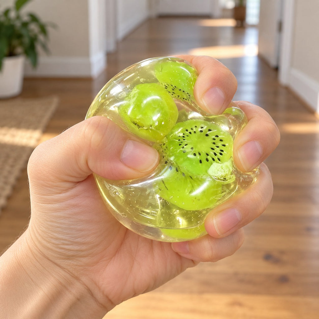 Fruit squishy (Kiwi), being squeezed by hand, soft and squishy