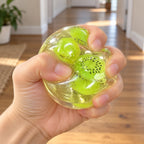 Fruit squishy (Kiwi), being squeezed by hand, soft and squishy