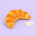 Croissant squishy slow rising – Croissant Squishy, Realistic Slow Rising Bread (12.5 cm), product photo on pastel paper