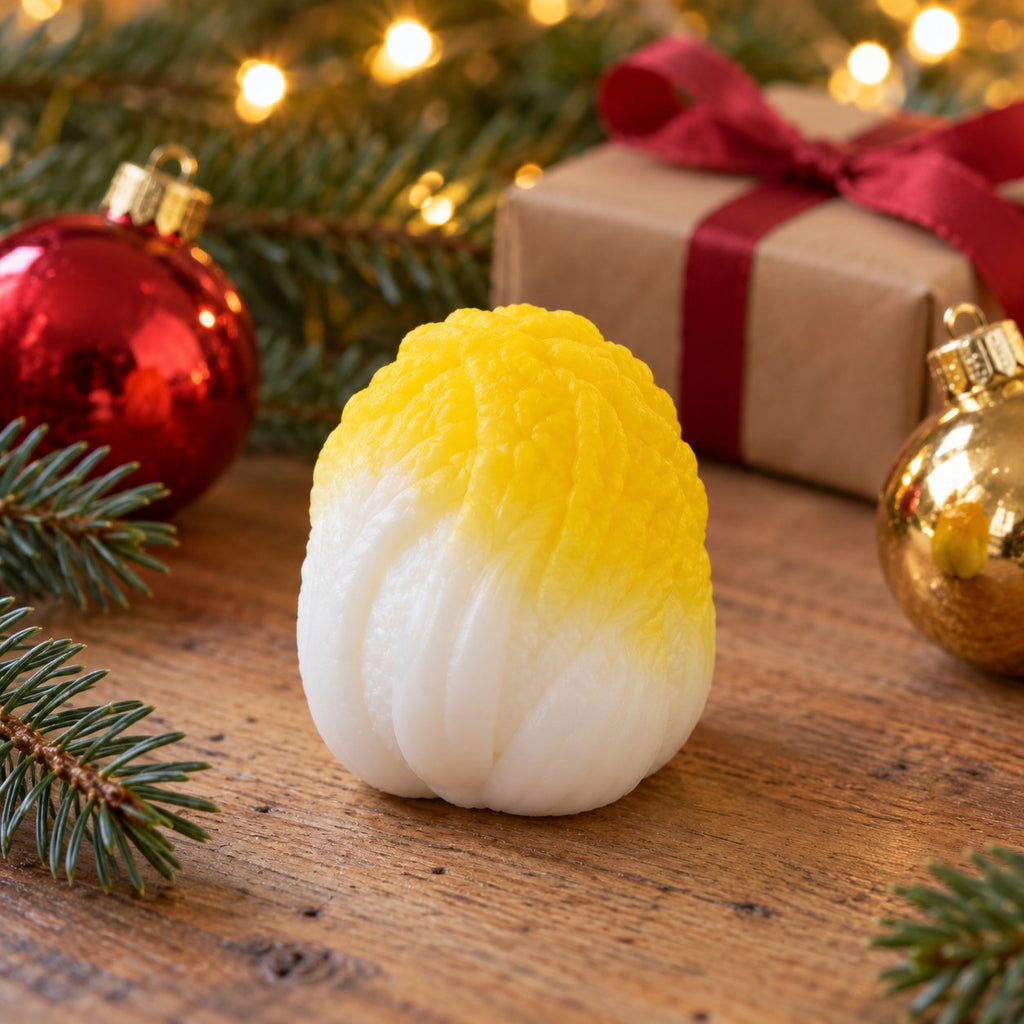 Crunchy Cabbage Squishy, Handmade (Yellow), in a Christmas scene with fir branches and fairy lights