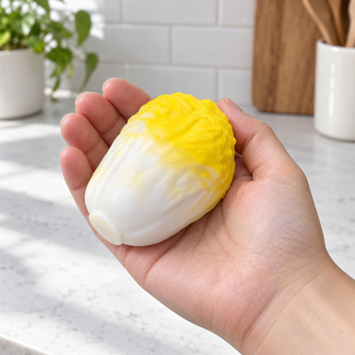 Crunchy Cabbage Squishy, Handmade (Yellow), held in a hand to show the real size