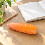 Crunchy Carrot Squishy, Crispy PU Vegetable, on a desk with a notebook and pencil