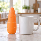 Crunchy Carrot Squishy, Crispy PU Vegetable, next to a coffee mug for size comparison