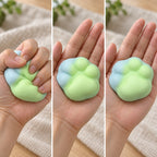 Cat paw squishy mini (green), squished flat, half risen and fully back in shape